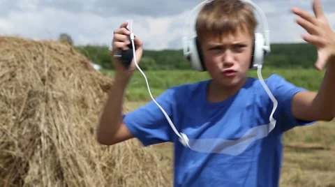Boy rapping on the background of haystack in roll outdoors Stock-Footage 53416809