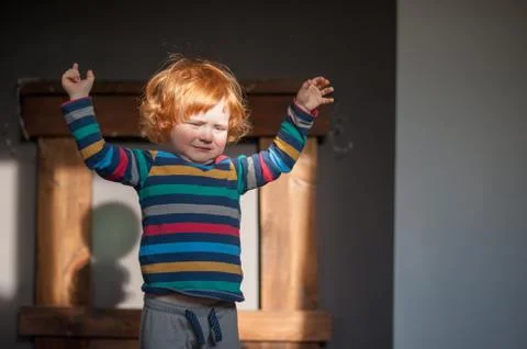 The boy in the rays of bright light Stock Photos