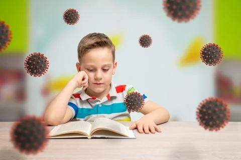 Boy read book and learn at home at the time of the virus corona epidemic. Cor Stock Photos