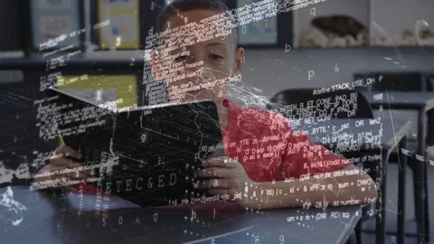 Boy reading black book, causing world map and code overlay growing across frame Stock Footage 333540207