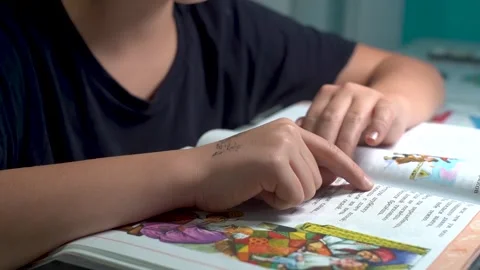 A boy is reading a book. Close-up. Stock Footage 256040729
