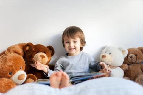 Boy, reading a book, educating himself Stock Photos