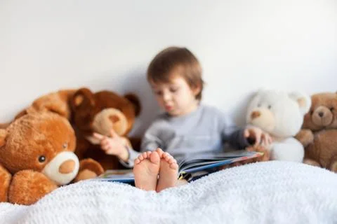 Boy, reading a book, educating himself Stock Photos