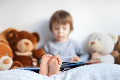 Boy, reading a book, educating himself Stock Photos