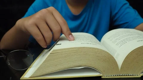 Boy reading a book at night. Stock Footage 182473096