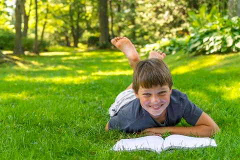 Boy reading a book Stock Photos