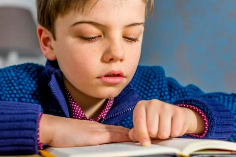Boy reading a book Stock Photos