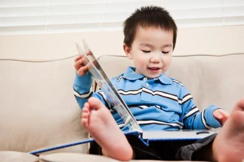 Boy reading a book Stock Photos