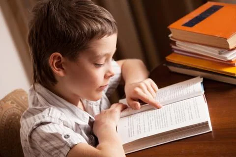 Boy reading book Stock Photos