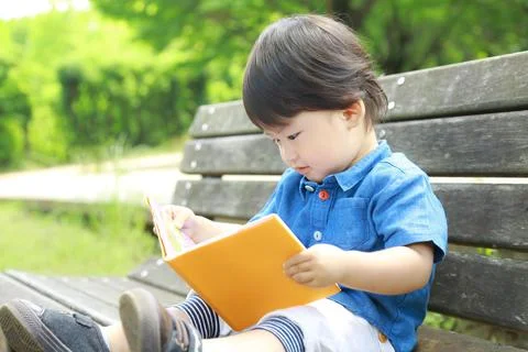 Boy reading a book Stock Photos