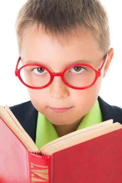 Boy reading a book thirsty for knowledge - isolated over a white background Stock Photos