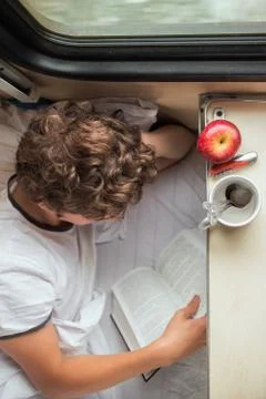 Boy reading a book on the train Foto stock