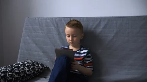 Boy reading e-book Video stock 99110995
