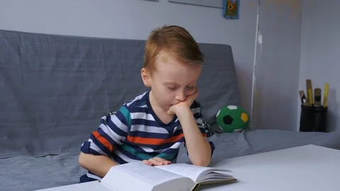 Boy reading e-book Stock Footage 99111896