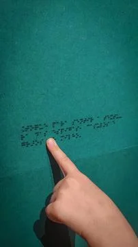 A boy reading the evacuation plan on the wall in braille. Close-up of a child Stock Photos