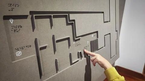 A boy reading the evacuation plan on the wall in braille. Close-up of a child Foto stock