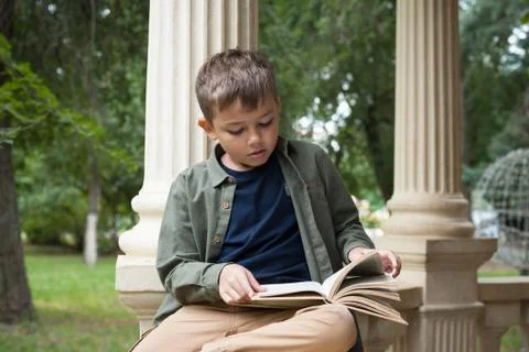 Boy reading in the Park Stock Photos