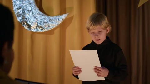 Boy Reading Script During Audition in Theatre Stock Footage 303057247