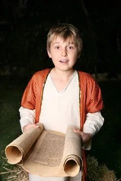 Boy reading a scroll Boy reading from a gevil parchment scroll. This one i... Stock Photos
