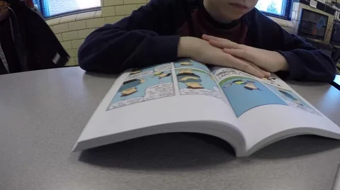 Boy Reading at Table in School Stock Footage 50604070