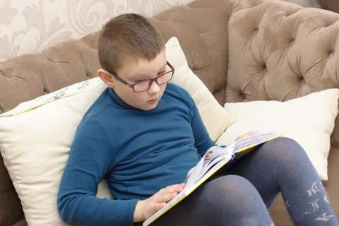 Boy reading a thick book Stock Photos