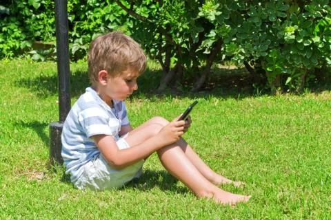 The boy reads the e-book Stock Photos