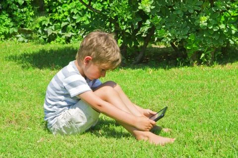 The boy reads the e-book Stock Photos