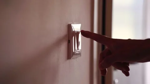 The boy realizes that the light is on during the day, so he turns it off Stock Footage 158055762