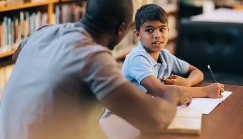 Boy receiving tutoring and academic support in primary school Stock Photos