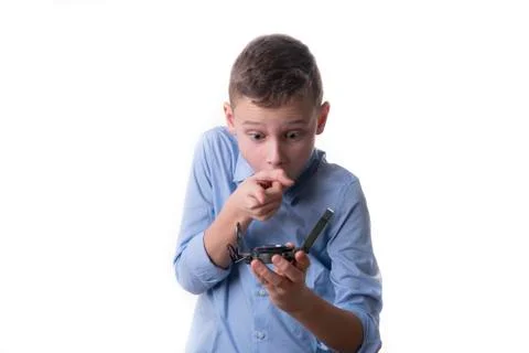 Boy recognizes on a compass in his hand the right direction for the future on Stock Photos