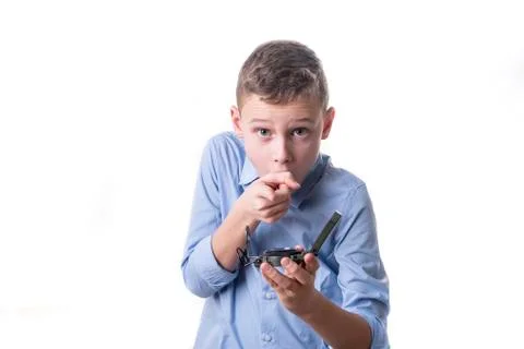 Boy recognizes on a compass in his hand the right direction for the future on Stock Photos