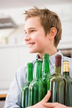 Boy recycling empty bottles Stock Photos