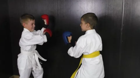 Boy with red and blue pads on his hands train sparring punches Stock Footage 157069739