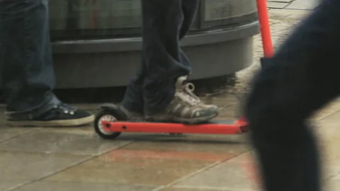 Boy in Red Jacket Riding a Red Scooter on the Street Stock Footage 88193256