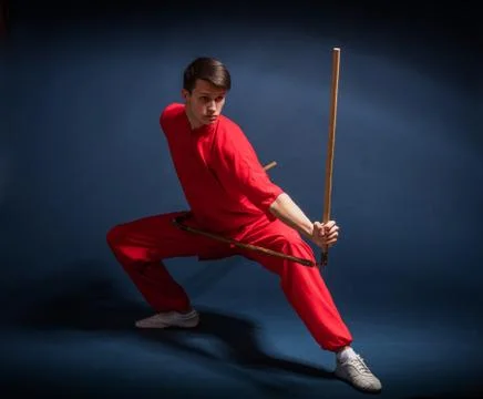 Boy in a red kimono engaged wushu 写真素材