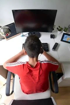 Boy with red t-shirt in the computer Stock Photos