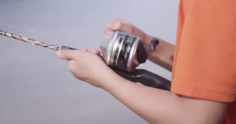 Boy reeling in fish Stock Footage 137059168