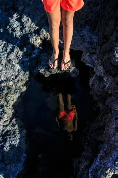 Boy reflected in the water Stock Photos