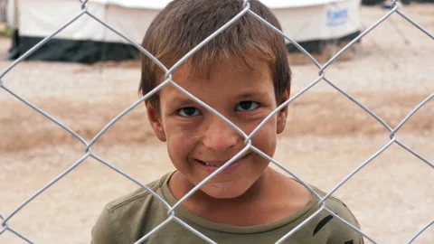 Boy from a refugee camp looked into the camera and smile. Mosul, Iraq. Stock Footage 158377658