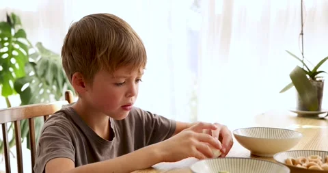 Boy refusing to eat boiled egg for breakfast Stock Footage 294673787