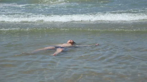 Boy relaxed lying on his back on top of the water Stock Footage 52822872