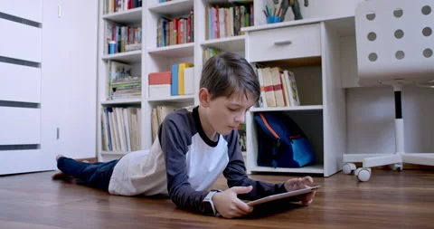 Boy relaxing and online learning on digital tablet. Stock Footage 135027497