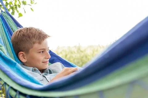 Boy relaxing in hammock Stock Photos