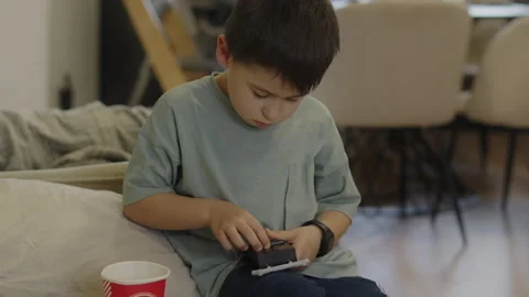 Boy repairing the portable console so he can play games. Modern for game design Stock Footage 247166643