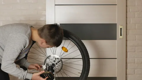 Boy repairs the bike Stock Footage 147322926