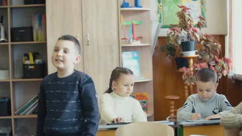 The boy is responsible standing at his desk Stock Footage 100887910