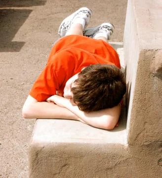 Boy resting on bench-1 Photos