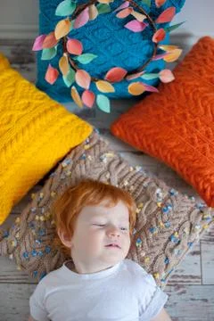 The boy is resting on pillows Stock Photos