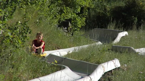 Boy rides alpine slide at Park City Base ski resort in Park City, Utah. Stock Footage 47218917