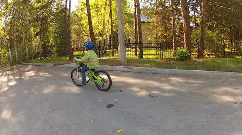 Boy rides on a bike Stock Footage 12364686